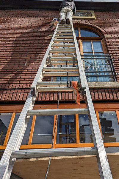 PAinter on a ladder downtown victoria